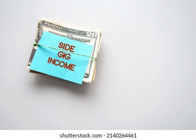 On white copy space background, dollars cash money with text note SIDE GIG IMCOME, financial planning - make more money or extra earning from part time side hustle, second job to increase income - Shutterstock ID 2140264461