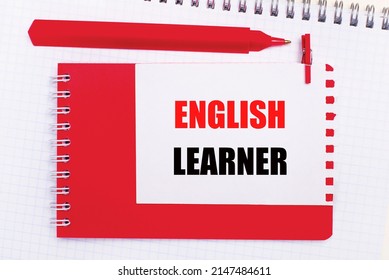 On A White Notepad, A Red Pen, A Red Notepad And A White Sheet Of Paper With The Text ENGLISH LEARNER