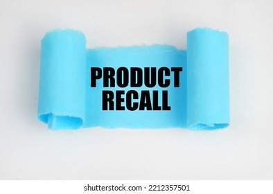 On A White Surface, A Blue Scroll Of Paper With The Inscription - PRODUCT RECALL. Business Concept.