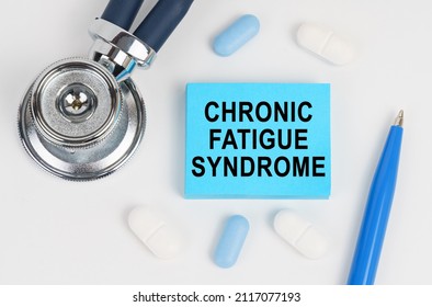 On a white surface lie pills, a stethoscope and stickers with the inscription - Chronic fatigue syndrome