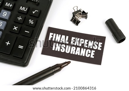 On a white table there is a calculator, a marker and a black plate with the inscription - Final Expense Insurance