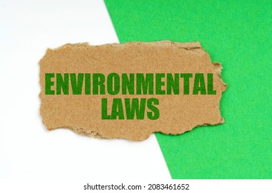 On A White-green Background Lies A Piece Of Cardboard With The Inscription - Environmental Laws