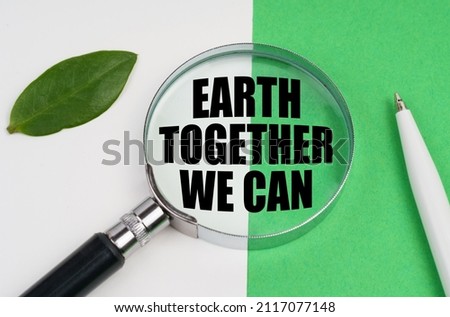 On a white-green background, a pen, a piece of paper and a magnifying glass with the inscription - Earth Together We Can
