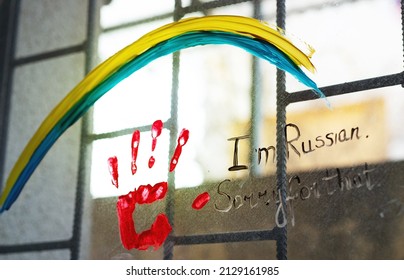 On The Window Is Painted Ukrainian Flag And Blood Hand Where Is Written I Am Russian, Sorry For That. Concept Of New Protest Move