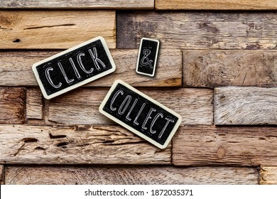on wooden background, small slates with the text 
				"Click and collect"  has been added digitally 