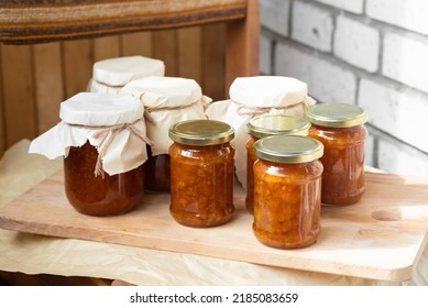 on wooden fabric background there are beautiful glass jars with orange sweet jam from orange berries of northern cloudberries from Karelia. several fresh berries lie on golden lids with  green leaves - Shutterstock ID 2185083659