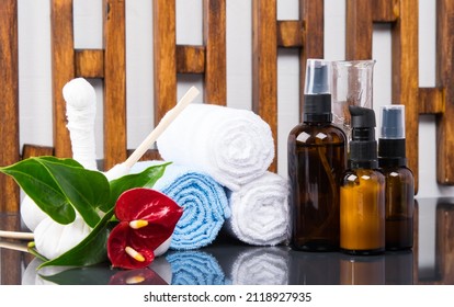 On A Wooden Striped Background, Items For Spa Treatments, A Towel Wrapped In A Roll, Bags For Massage And Aroma Oils