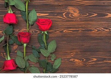 On a wooden surface are red roses - Powered by Shutterstock