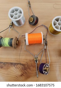 On A Wooden Table Reels With Different Threads. Tools For Making Fishing Lures.