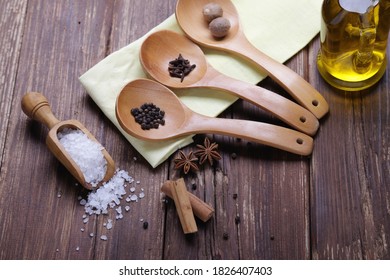 On a wooden table various spices and coarse salt - Powered by Shutterstock