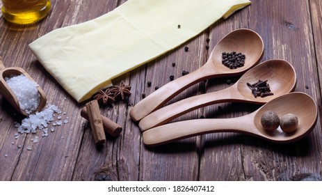 On a wooden table various spices and coarse salt - Powered by Shutterstock