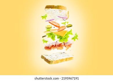 On A Yellow Background, A Sandwich With Pieces Of Meat, Vegetables, Cheese, Herbs In A Frozen Flight. Creative Composition. Minimalism. There Are No People In The Photo.