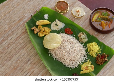 Onam sadhya served in banana leaf, south indian vegeterian meal arranged in traditional way,top view