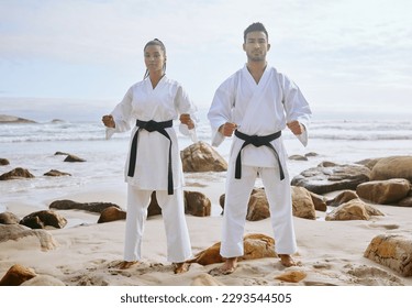 Once a kata has been learned, it must be practiced repeatedly. Portrait of two young martial artists practicing karate on the beach. - Powered by Shutterstock