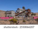 A once rich lead and silver mine with headgear and other assets, that has now been abandoned as the ore has run out, situated on the line of lode in Broken Hill in New South Wales, Australia.