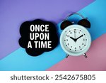 Once Upon A Time text on speech bubble with alarm clock top view on blue, purple and pink geometric background