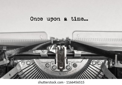 once upon a time... the text is typed on a vintage typewriter with black ink on old paper, close-up