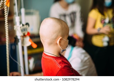 Oncological Child Is Playing In Hospital In Medical Mask In The Room