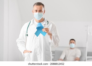 Oncologist With Blue Ribbon In Clinic. Prostate Cancer Awareness Concept