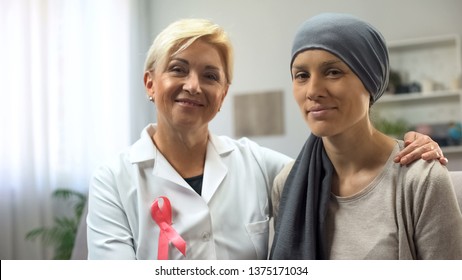 Oncologist And Cancer Patient Looking Into Camera, Hoping For Healing Survival