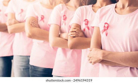 Oncology Prevention. Group Of Unrecognizable Multiracial Ladies In Pink Cancer Awareness T-Shirts Standing Posing Over White Background. Panorama, Shallow Depth - Powered by Shutterstock