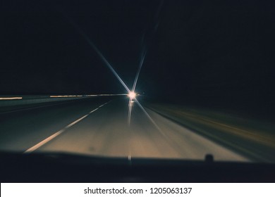 The Oncoming Car Dazzles With High Beam On The Road