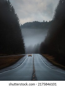 Oncoming Car Over Misty Freeway