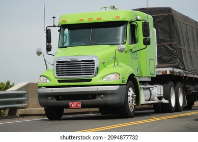 Oncoming green truck with tarped load  Corning CA USA  May 2010