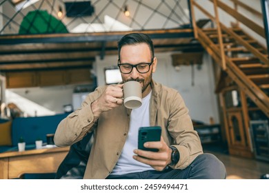 One adult caucasian man with eyeglasses sit at home and hold cup of coffee enjoy and relax at home - Powered by Shutterstock