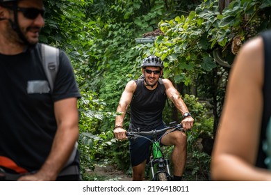 One Adult Caucasian Man Ride Electric E-bike Bicycle In Sunny Summer Day Getting Ready In Front Of The House Wear Protective Helmet And Eyeglasses Real People Copy Space In Group Of People