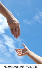 One Adult Hand Reaches Out To Help Child Hand In Need