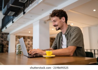 One Adult Modern Man Caucasian Male With Beard And Mustaches Wear Causal Shirt Working Remote From Cafe Freelance Work Or Blog Checking Online Content Or Browsing Internet While Sitting Alone