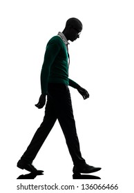 One African  Black Man Walking Looking Down Sad  In Silhouette Studio On White Background