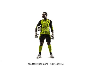 One african male soccer player goalkeeper standing and holding ball. Silhouette isolated on white studio background - Powered by Shutterstock