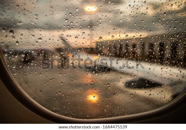one airplane window with
rain