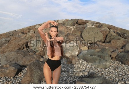 Similar – Young woman standing with closed eyes at the Baltic Sea beach