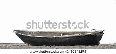 one, alone Fishing boat empty, wooden abandoned on pebble coast of Black Sea. Old vessel moored on shore, calm transparent sea background. Summer. Kobuleti, Georgia. isolated on white background