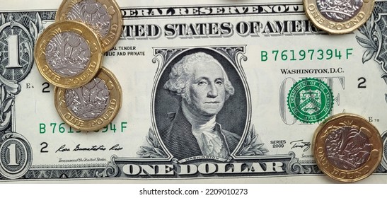 One American Dollar Bill With British Pound Coins Overlaid - Exchange Rate Concept. Flat Lay In A Web Banner Format.