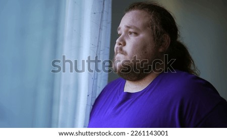 One anxious chubby man feeling worry and anxiety. Desperate person ruminating thoughts in head looking out by window