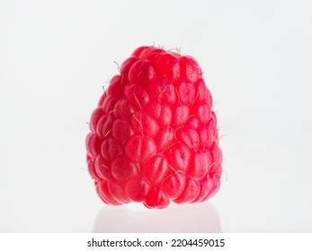 One Appetizing Ripe Red Raspberry Isolated On White Background. Minimalism. Close-up. Vitamins, Antioxidants. Healthy Food, Healthy Lifestyle. There Are No People In The Photo.