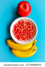 one apple , pomegranate , two bananas  - Shutterstock ID 2174908295