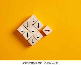 One arrow moves the opposite direction than the others. Unique, think different, individuality, standing out from the crowd and choosing a different path in business and life concepts. - Shutterstock ID 2223250741