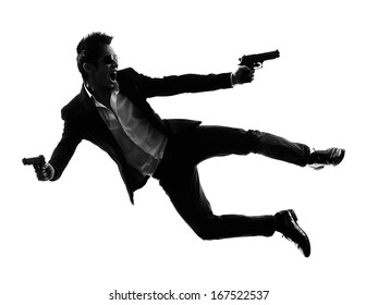 One Asian Gunman Killer Jumping Shooting  In Silhouette Isolated White Background