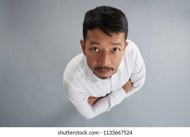 One Asian Man With Crossed Arms Isolated On Gray Background Above Top View