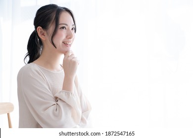 One Asian Woman Thinking At Home