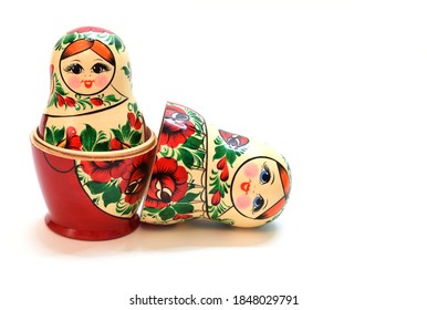 One assembled nesting doll inside another large one and a head lying near by