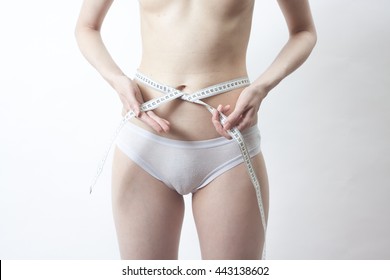 One Attractive Caucasian Girl In White Panties With A Centimeter Measuring Hips And Waist On White One Attractive Caucasian Girl In White Panties With A Centimeter Measuring Hips And Waist On White