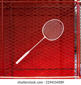 One Badminton Racket Is Hung On Red Grill By A Cable Tie For Display In Exhibition Sports Event