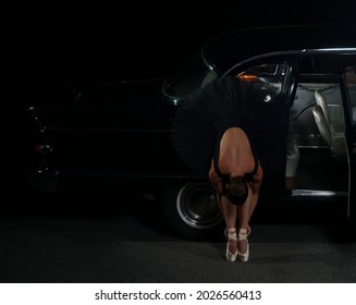 One Ballet Dancer Flexion Near Black Vintage Car. Night Scene. 