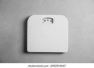 One bathroom scale on grey textured background, top view - Powered by Shutterstock